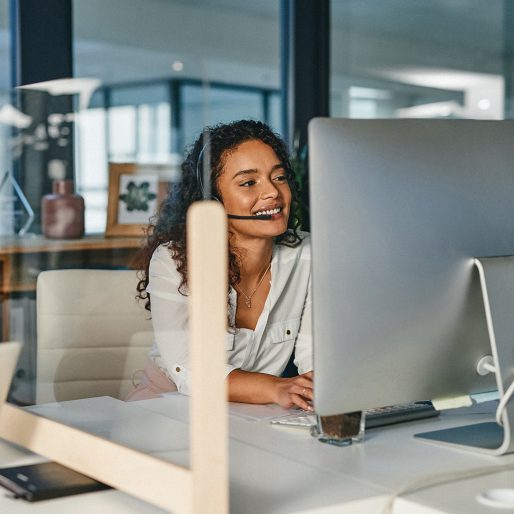 Shot of a young call centre agent working on a computer in an office