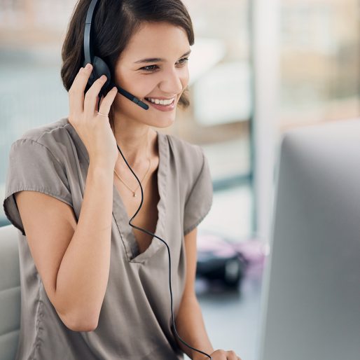 Cropped shot of a woman using a headset while sitting at her desk in the office